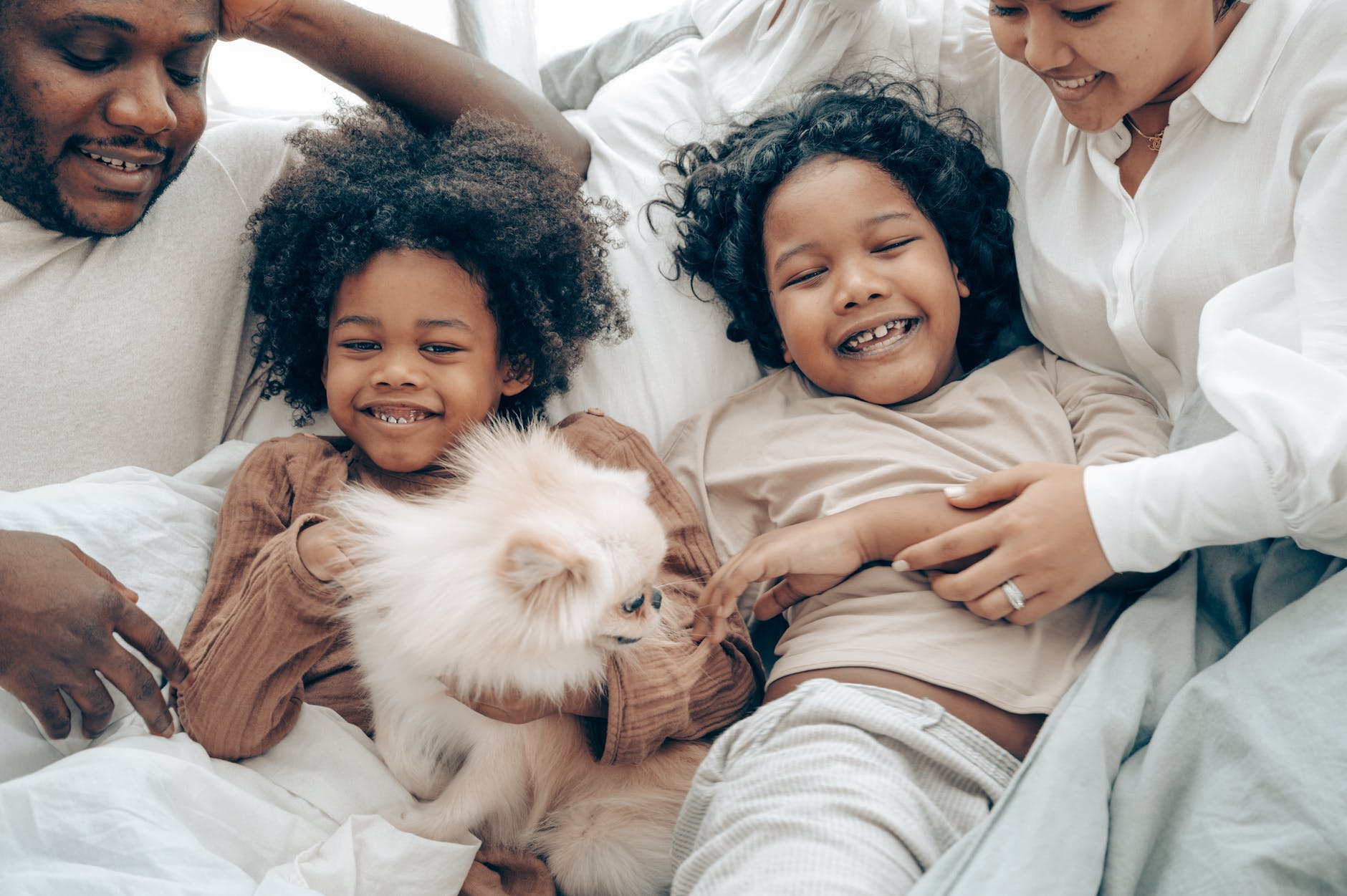 cheerful family having together with their dog